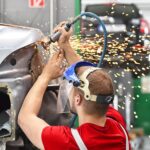 car body repair by mechanic red
