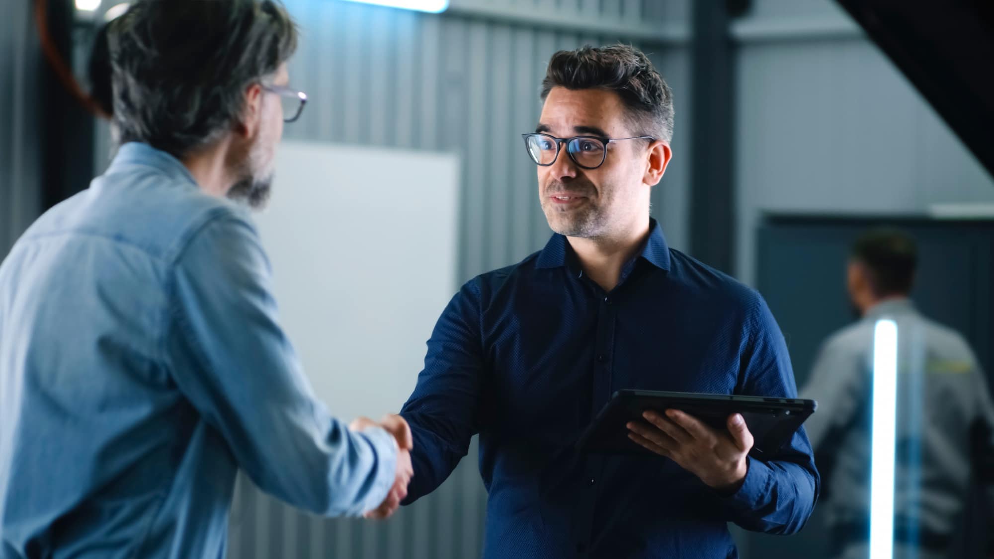 manager shaking hands with a client after car diagnostics in car service shop manager shaking hands with a client after car diagnostics in car service shop