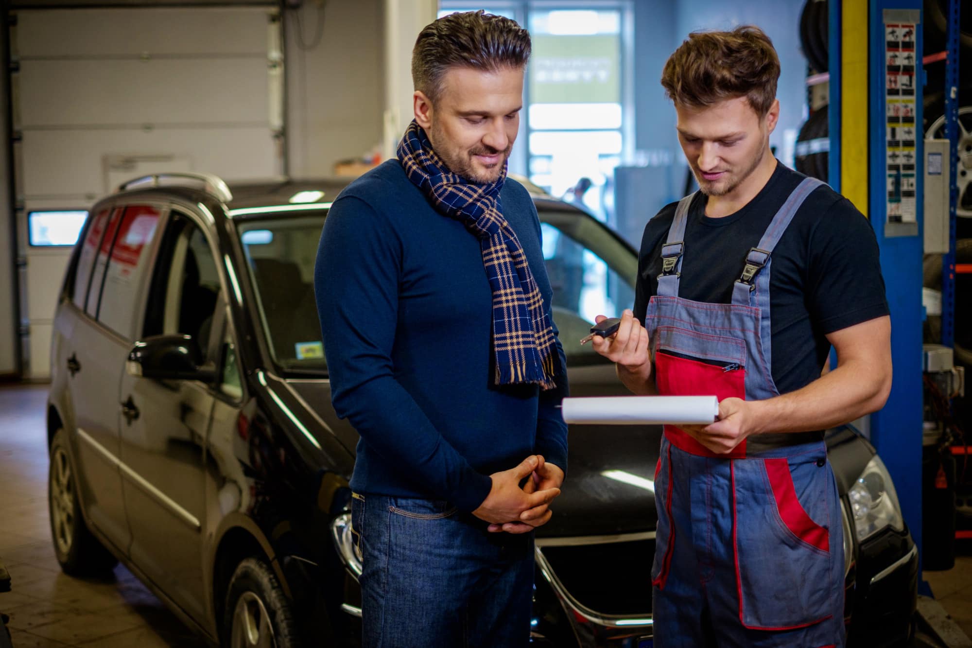 mechanic explains car repair plan to a client mechanic explains car repair plan to a client